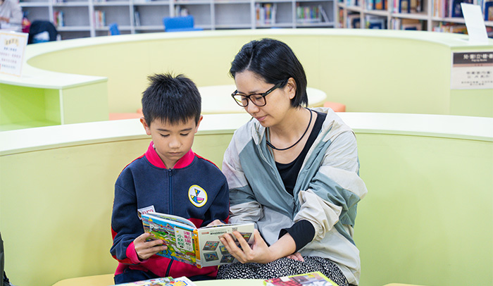 民眾於假日帶家中孩童至圖書館共讀，享受悠閒的親子時光。