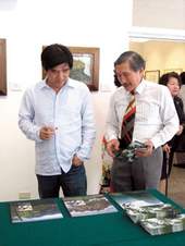 台灣藝術大道促進協會理事長曾明男(右)向邱主委介紹協會以九九峰為主題的創作