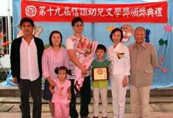 第19 屆信誼幼兒文學奬3～8 歳圖畫書創作組首奬得主陳和凱(中間捧花者)，偕同家人與文建會主委邱坤良(左1)、信誼基金會董事長何壽川(右1)、執行長張杏如(右2) 合影。