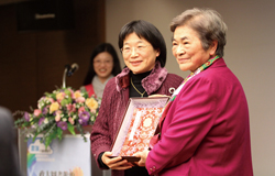 國立政治大學圖書館館長蔡明月(左)代表致贈生日禮物給胡歐蘭教授